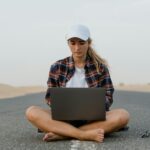 digital nomad working laptop beach